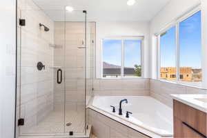 Master bathroom with a garden tub, a stall shower, vanity, and recessed lighting