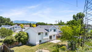 Rear view of property with a patio, a mountain view, a residential view, cooling unit, and roof with shingles