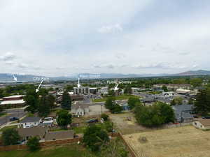 Aerial view of property's location with a mountain backdrop and nearby suburban area