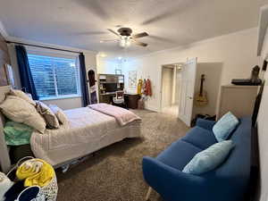 Basement bedroom 2- Carpeted bedroom with ornamental molding, a ceiling fan, a textured ceiling, and baseboards