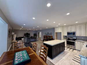Basement Kitchen featuring stainless steel appliances, recessed lighting, a center island, Granite stone countertops, and open floor plan