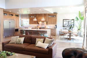 Living area with light wood-style floors, a chandelier