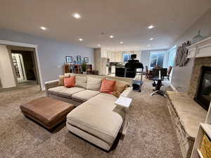 basement greatroom-Living area with light colored carpet, a fireplace, recessed lighting