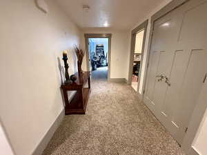 Hall featuring baseboards and carpet floors