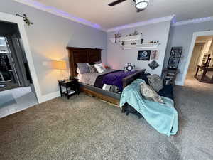 basement Bedroom  1-with crown molding, carpet flooring, and baseboards
