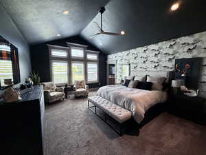 Carpeted bedroom featuring vaulted ceiling, a textured ceiling, recessed lighting, and ceiling fan