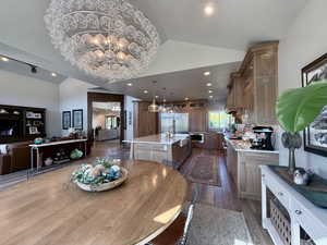 Dining room featuring vaulted ceiling, a Custom handmade blown glass chandelier