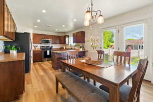 Dining area featuring recessed lighting, light wood-type flooring, and a chandelier