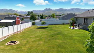 View of yard with an outdoor fire pit, a mountain view, and a residential view