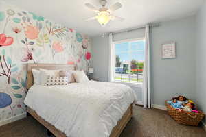 Bedroom featuring carpet flooring, baseboards, and ceiling fan
