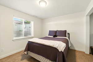 Bedroom with baseboards and carpet