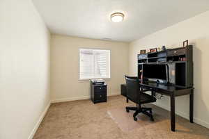 Office featuring carpet flooring, a textured ceiling, and baseboards