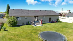 Back of property featuring roof with shingles and a gate