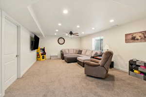 Living area with recessed lighting, carpet floors, a ceiling fan, and baseboards