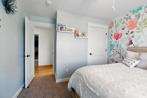 Bedroom featuring carpet flooring, baseboards, and a closet