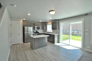Dining area featuring light wood-style floors, baseboards and a sliding door to the backyard.