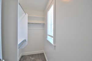 Spacious closet with light carpet off of the second bedroom upstairs.