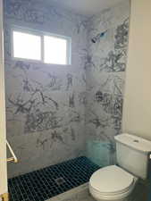 Full bathroom with a shower stall and toilet