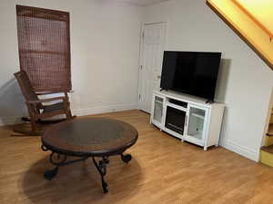 Sitting room with light wood-style floors and baseboards