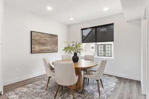 Model Home Dining room featuring wood finished floors, baseboards, and recessed lighting
