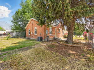 View of property exterior featuring brick siding and central AC unit