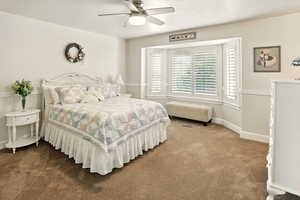 Bedroom featuring carpet flooring, baseboards, and ceiling fan