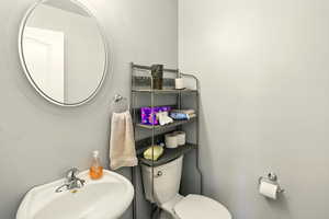 Half bathroom with a sink and toilet
