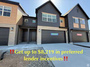 Townhome / multi-family property featuring brick siding, a garage, and concrete driveway