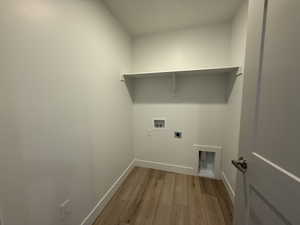 Laundry room featuring light wood-type flooring, hookup for a washing machine, electric dryer hookup, and baseboards
