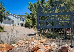 Community sign with gravel driveway
