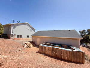 Rear view of property featuring stairs