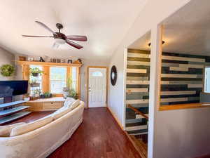 Foyer entrance featuring a ceiling fan, wood finished floors, a textured ceiling, and baseboards