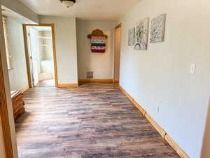 Hall featuring wood finished floors and baseboards