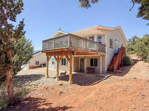 Rear view of property with a deck and stairway