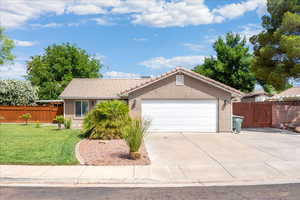 Ranch-style house featuring a garage, a tile roof, concrete driveway, and stucco siding