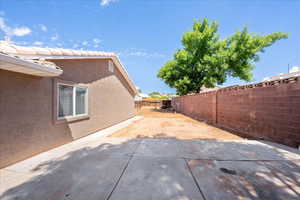 Fenced backyard with a patio