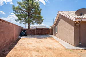 Fenced backyard featuring a gate