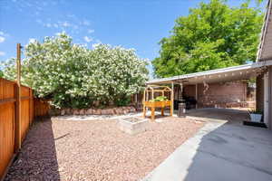 Fenced backyard featuring a patio and a fire pit