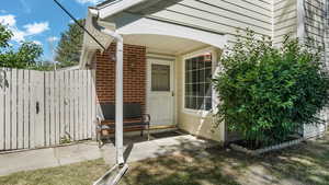 Doorway to property with brick siding