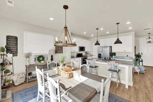 Dining area featuring light wood finished floors and recessed lighting