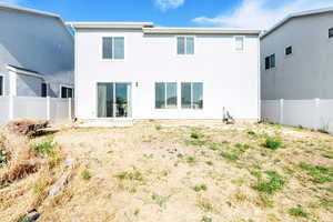 Back of property featuring stucco siding