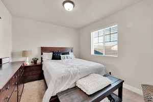 Bedroom with light carpet and baseboards