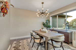 Formal dining space featuring a chandelier, and large window