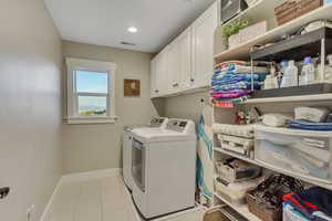 Laundry with cabinet space, washer and dryer (excluded),