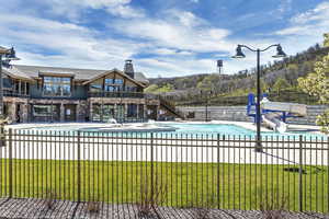 View of pool featuring a water slide, stairs, and a patio area