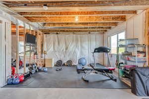 unfinished basement at ground level being used as an exercise room.
