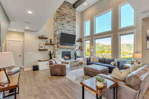 Family room area with 15 ft ceilings, tons of natural light, light wood flooring