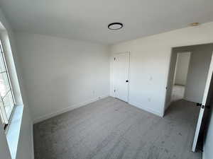 Unfurnished bedroom featuring carpet floors and baseboards
