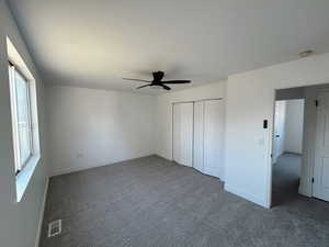 Unfurnished bedroom featuring carpet, ceiling fan, and baseboards