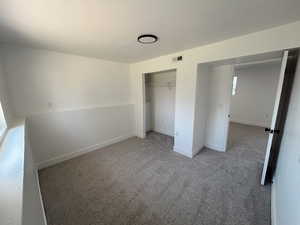 Unfurnished bedroom featuring carpet, a closet, and baseboards